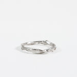 Sterling silver Nest Ring with a small lab-grown diamond inset in a twisted organic band, shown on a white background.