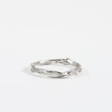 Sterling silver Nest Ring with a small lab-grown diamond inset in a twisted organic band, shown on a white background.
