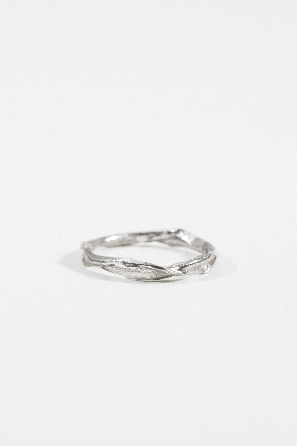 Sterling silver Nest Ring with a small lab-grown diamond inset in a twisted organic band, shown on a white background.