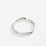 Top view of the sterling silver Nest Ring showing the small inset lab diamond and organic circular shape.