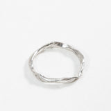 Top view of the sterling silver Nest Ring showing the small inset lab diamond and organic circular shape.