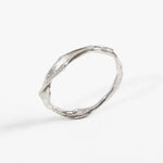 Side profile of the handcrafted sterling silver Nest Ring with a lab-grown diamond inset, resting on a white background.