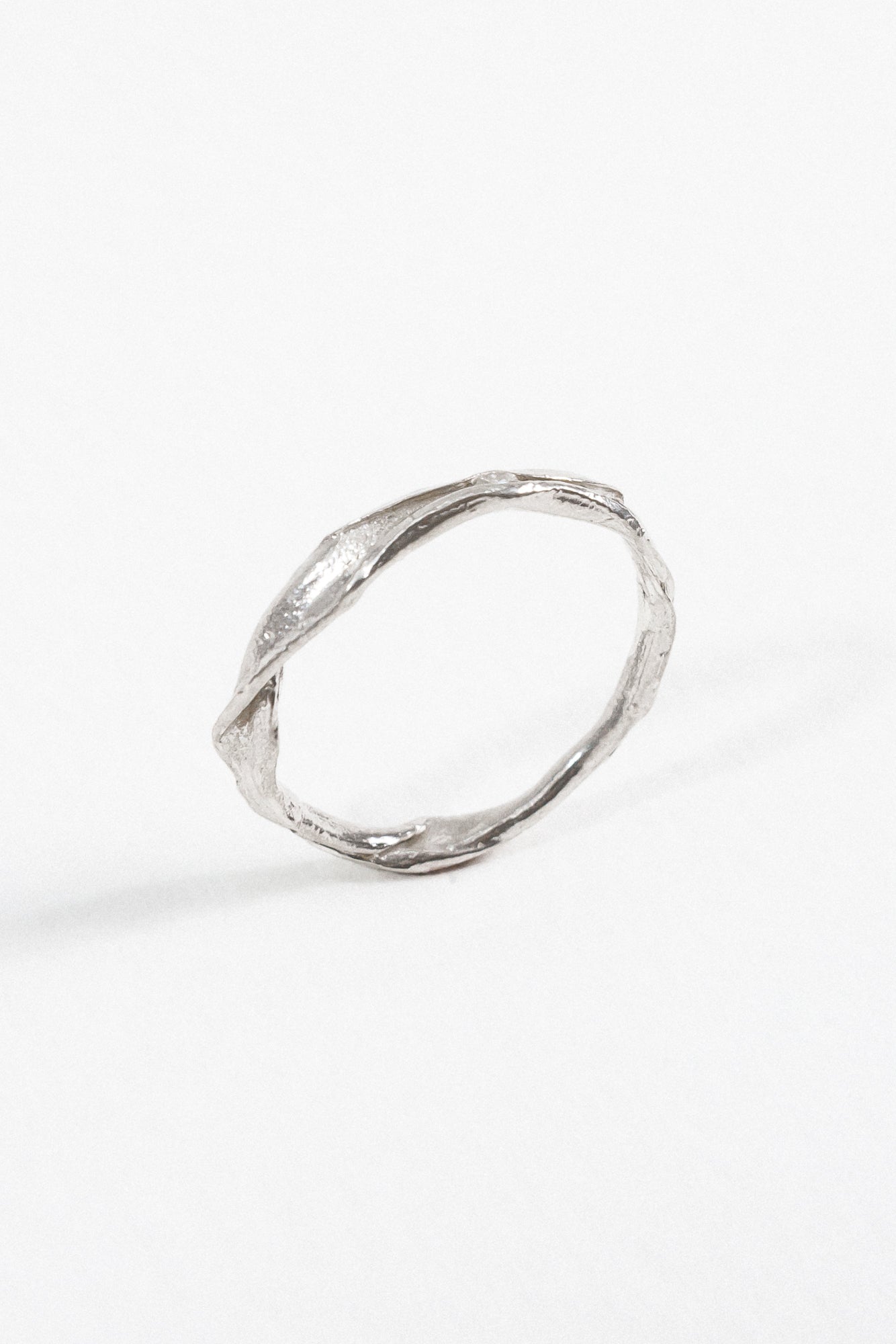 Side profile of the handcrafted sterling silver Nest Ring with a lab-grown diamond inset, resting on a white background.