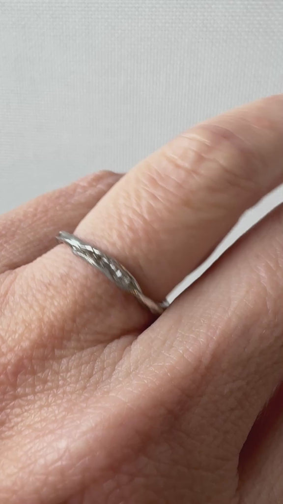Artisan silver ring with lab-grown diamonds worn on a finger, captured from a side angle.