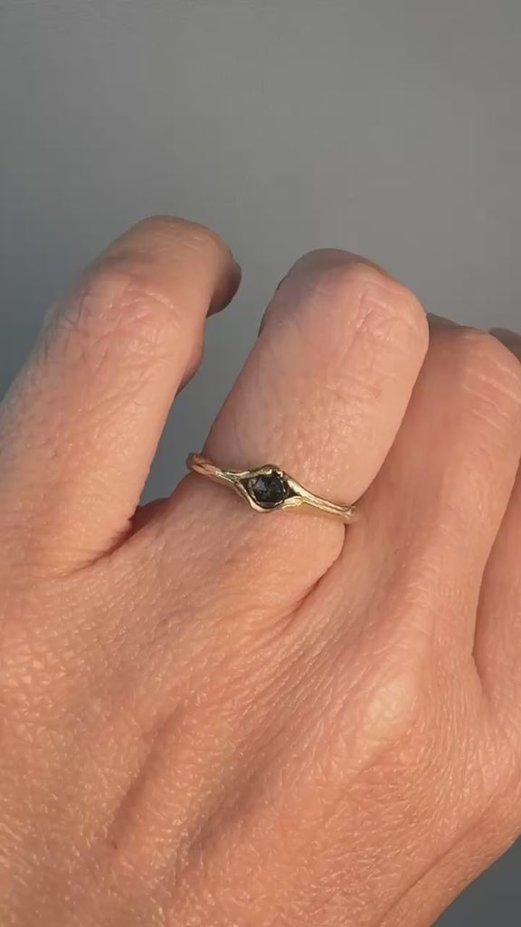 “Salt-and-pepper diamond ring in 10k yellow gold worn on the hand, photographed in cool lighting
