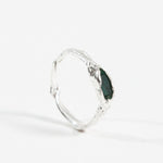 Side profile of the sterling silver Refuge Ring showing the organic handmade band and raw emerald.