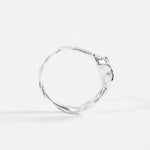 Back view of the sterling silver Refuge Ring highlighting the textured circular band without the gemstone visible.