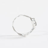 Back view of the sterling silver Refuge Ring highlighting the textured circular band without the gemstone visible.