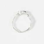 Top-down view of the handcrafted sterling silver Refuge Ring highlighting the irregular natural band.