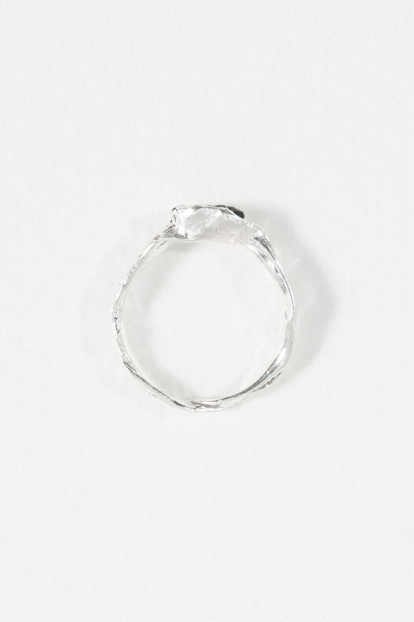 Top-down view of the handcrafted sterling silver Refuge Ring highlighting the irregular natural band.